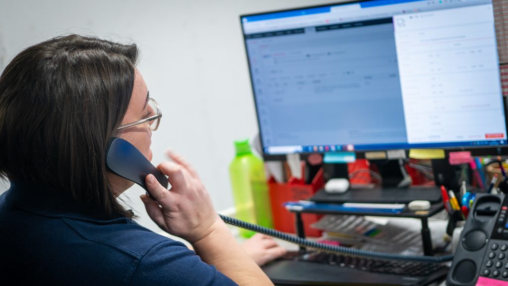 woman speaking on phone while using Clarity Go software