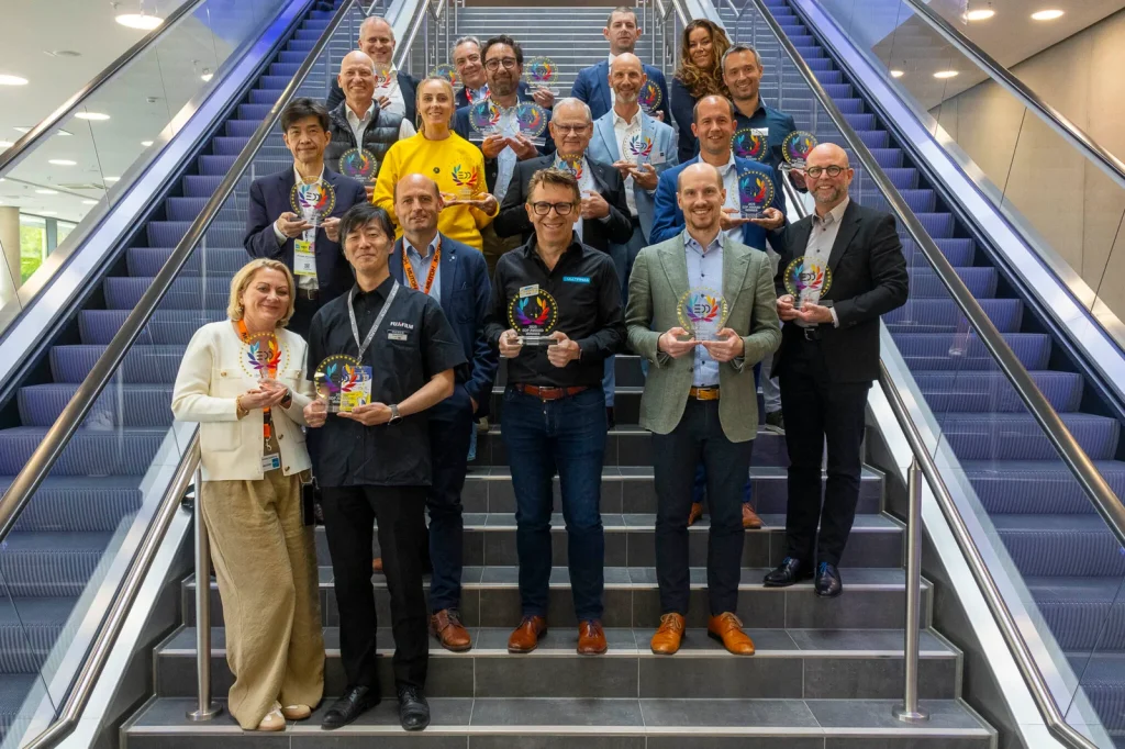 EDP awards - winners stand on staircase holding trophies