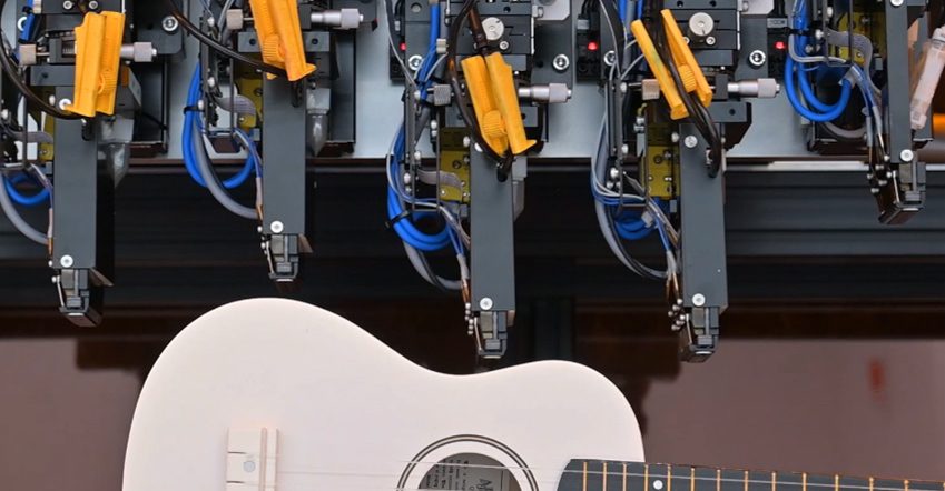 Epson's Direct to Shape Printing System printing on a guitar