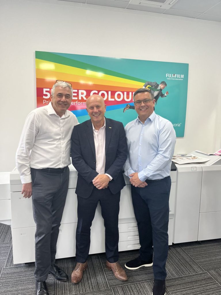 3 men stand in front of Fujifilm revoria printer at Jet technology group's new demo centre