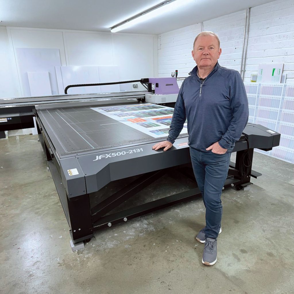 Prestige Signs' Production Director, John Nolan with the company's Mimaki JFX500-2131 flatbed UV printer