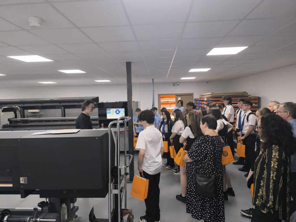Young people from local schools tour the expansive production floor of Graphic Warehouse to see large format print manufacturing