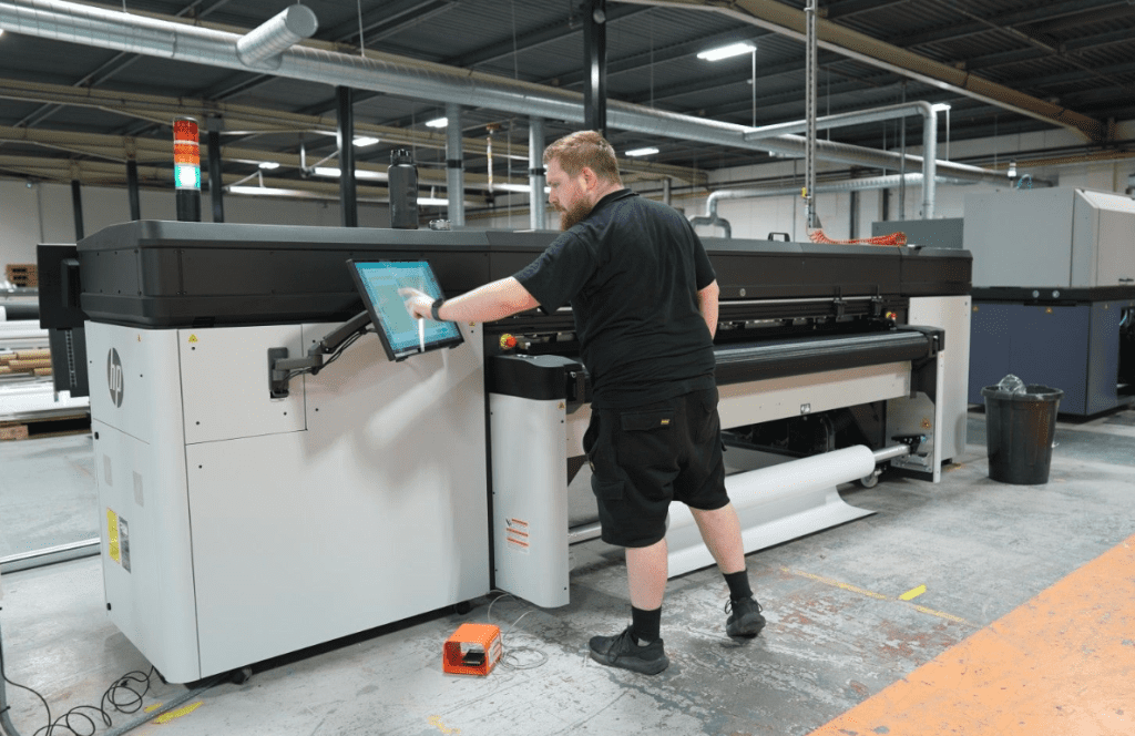 Man operating HP Latex R2000 printer