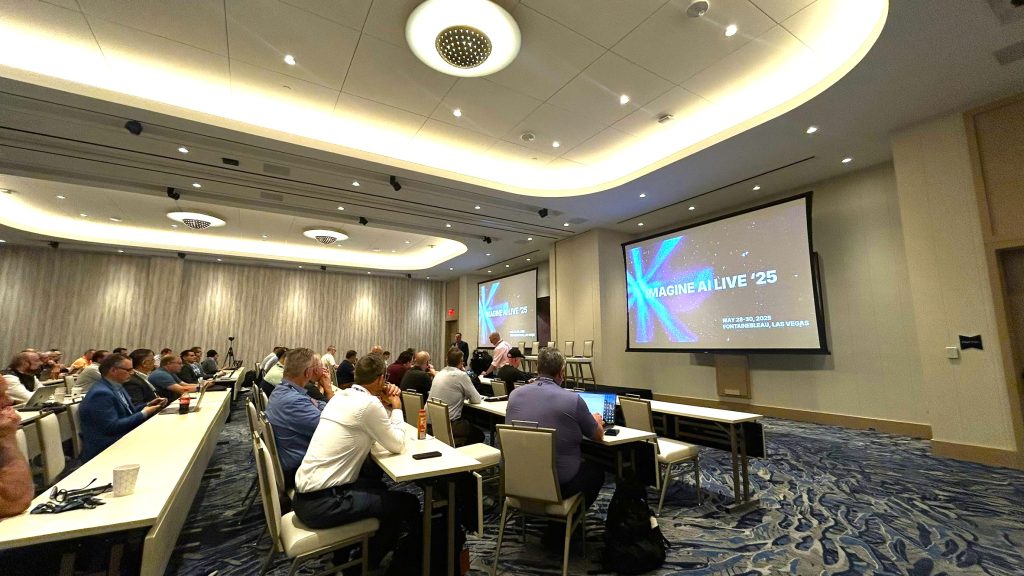 Image shows conference delegates listening to Steve Metcalf at IMAGINE AI Live event