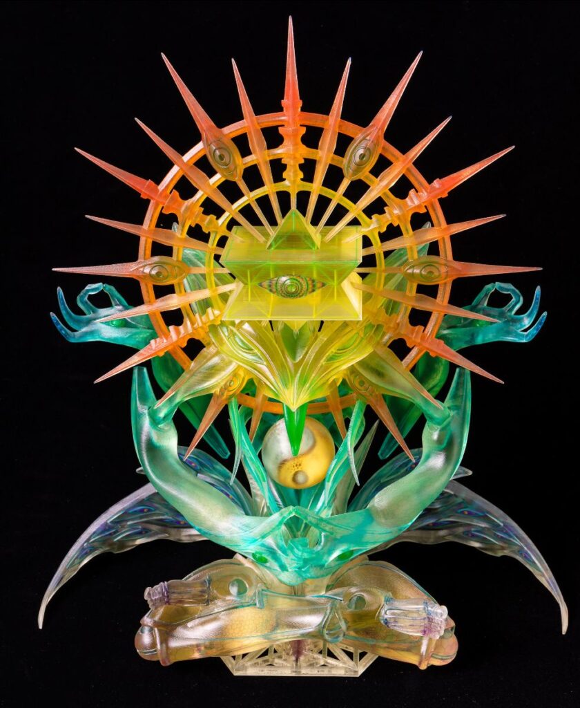 A complex, vibrant 3D printed sculpture by humanoise featuring geometric shapes and spiritual motifs, utilizing clear and coloured resins