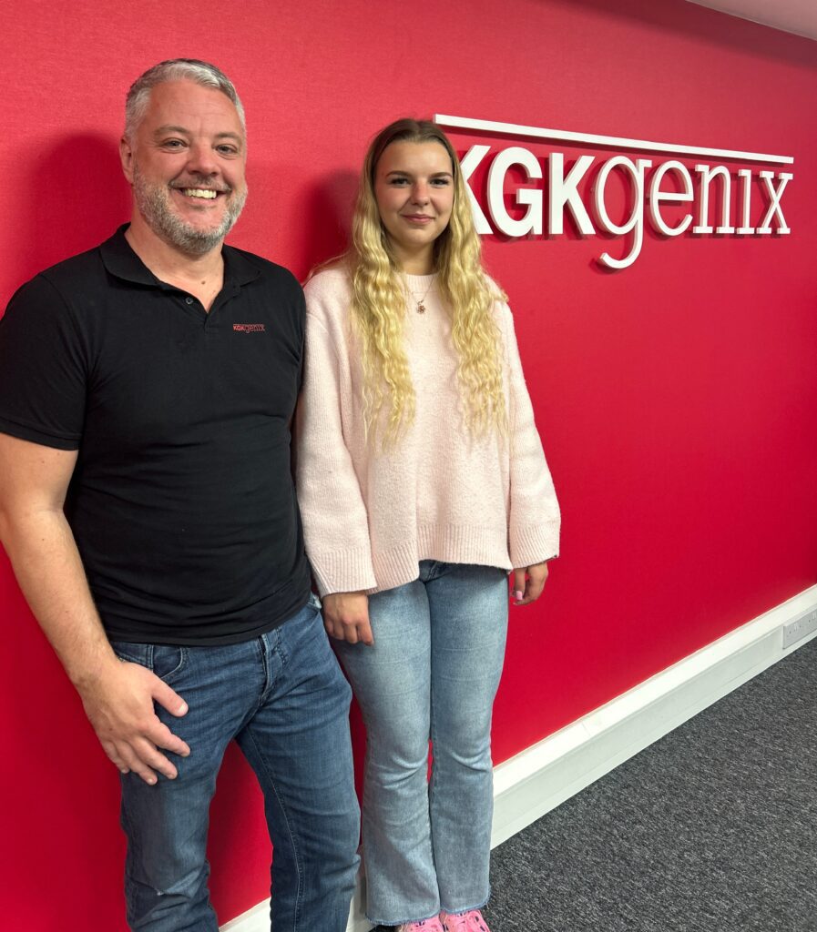 David Pitts and Wiktoria Markiewicz standing in front of KGK Genix branded wall