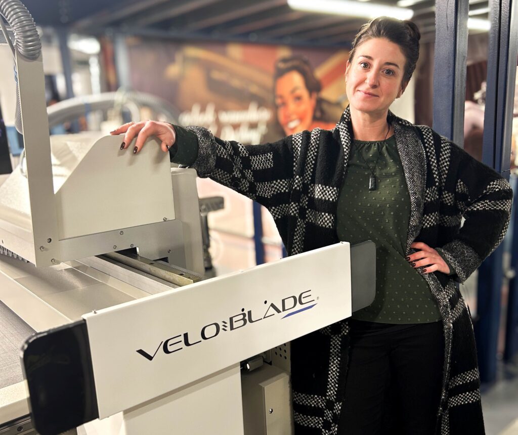 Roisin Hennessy, co-owner of Xtreme Signs & Graphics, stands alongside the company's new Veloblade Nexus 3032