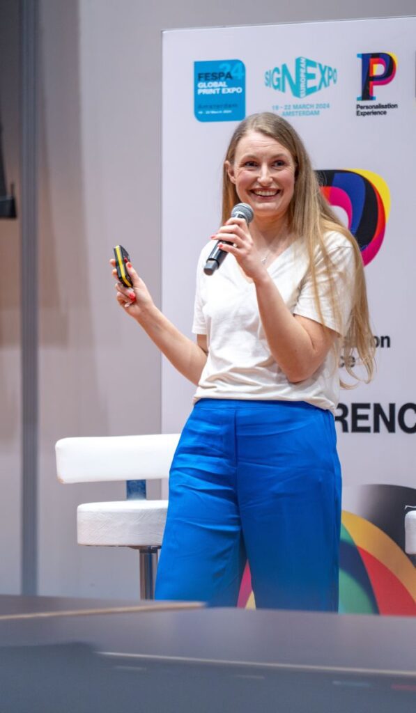 A speaker presenting to an audience at a FESPA industry conference.