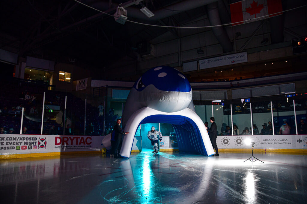 Ice hockey rink board advertising graphics installed at an arena.