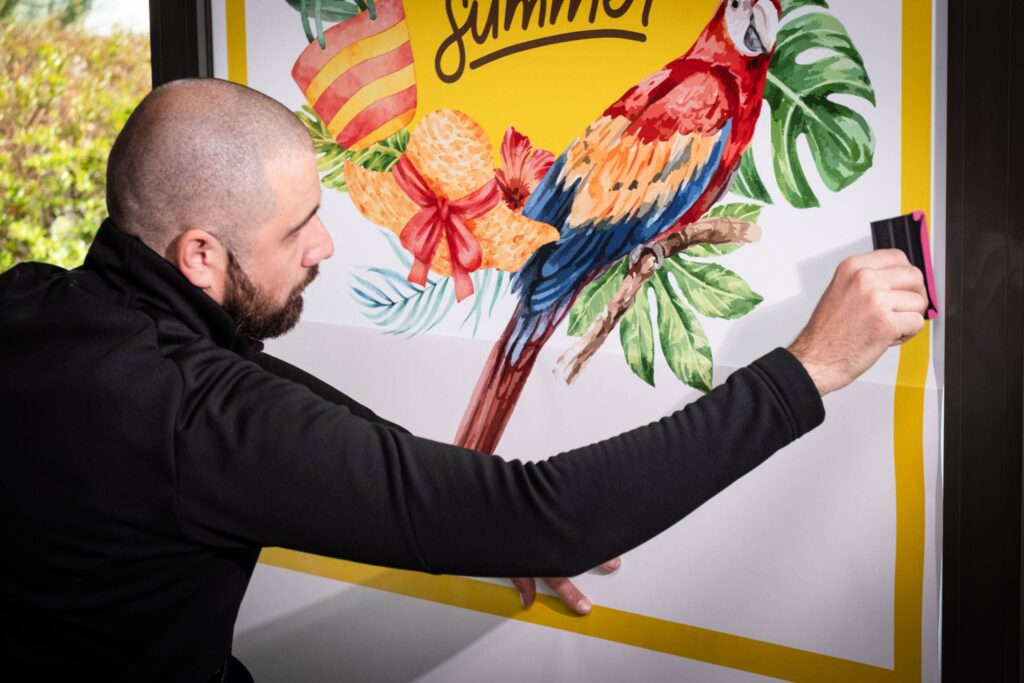 Man applying F-Print Natural Fibre 115 from Dorotape, printed with a colourful summer image. 