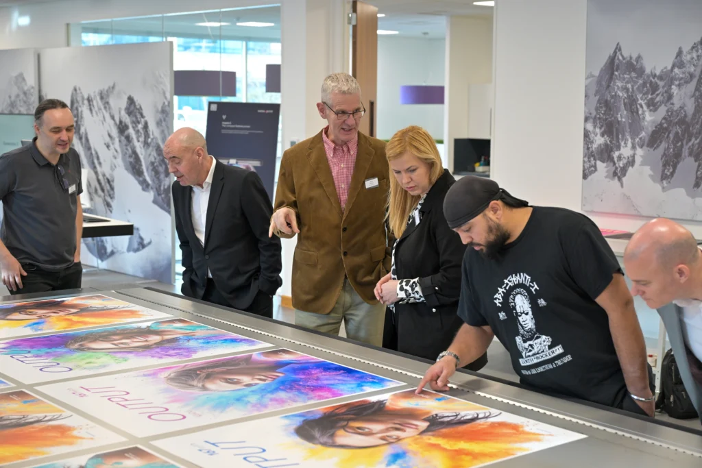 group examining images produced on swissQprint generation 5 flatbed printers at open day