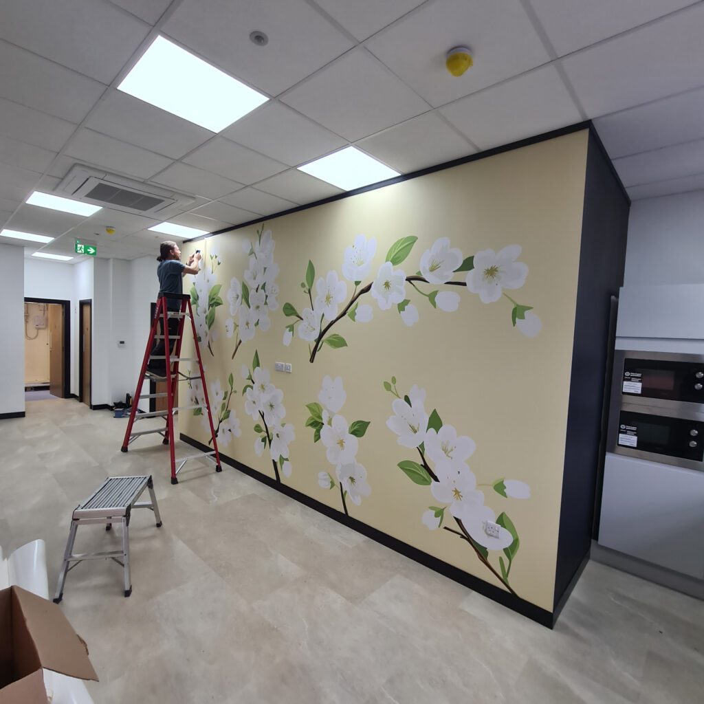 Vibrant interior wall graphics installed in a modern corporate office environment.