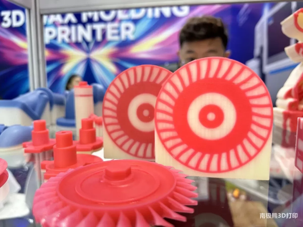 Red and cream 3D printed wax turbine patterns on a ZCZH wax moulding printer stand.