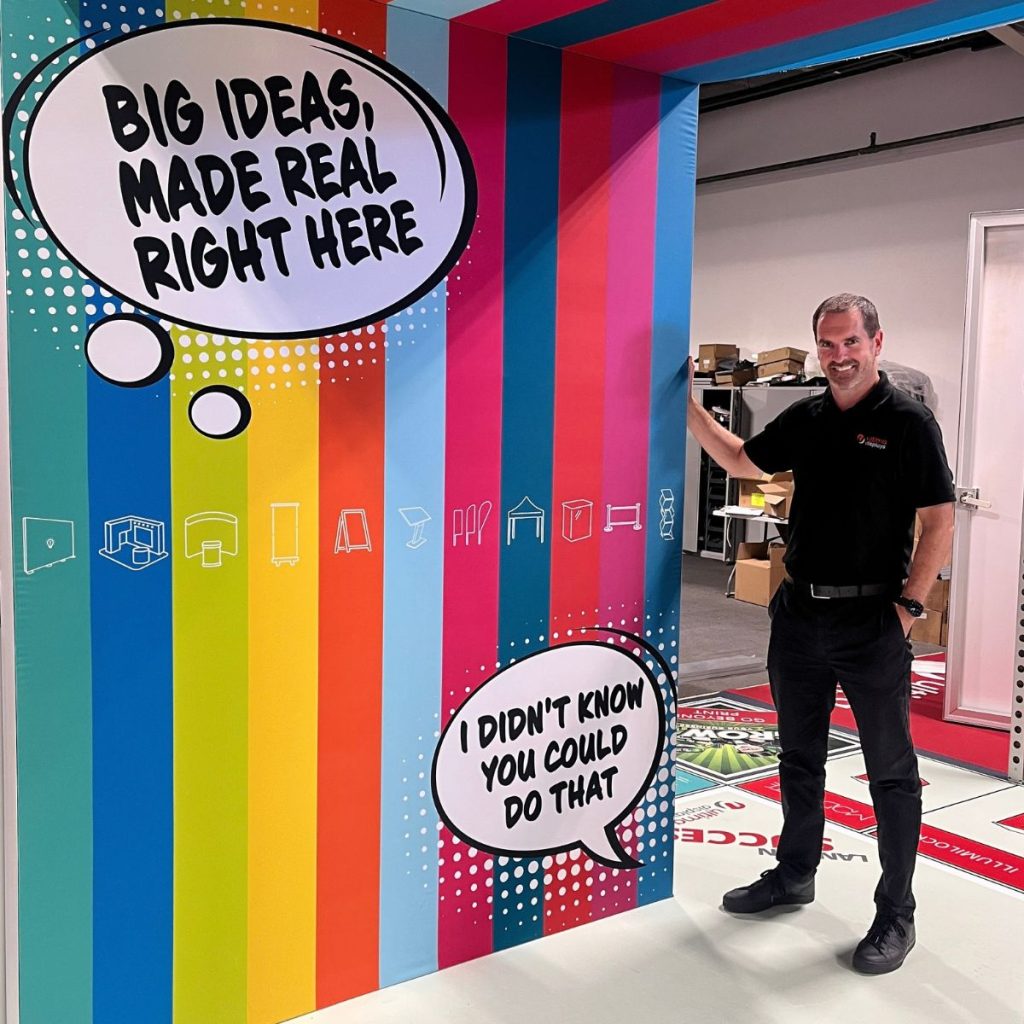 UK Managing Director at Ultima Displays, Andrew Cushing with a colourful modular exhibition stand