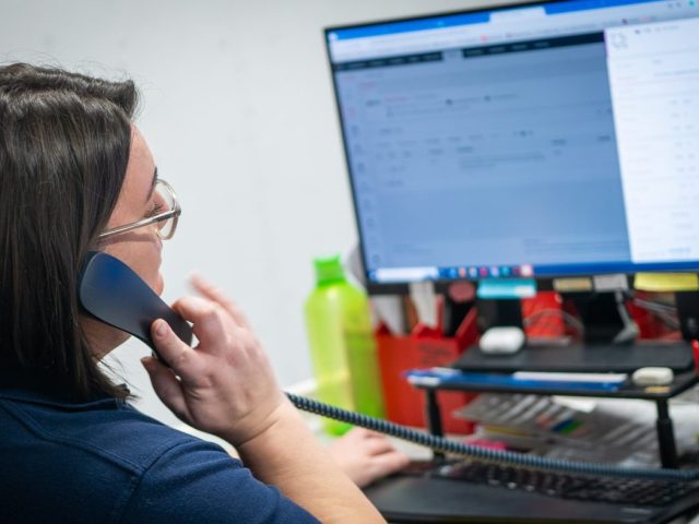 woman speaking on phone while using Clarity Go software