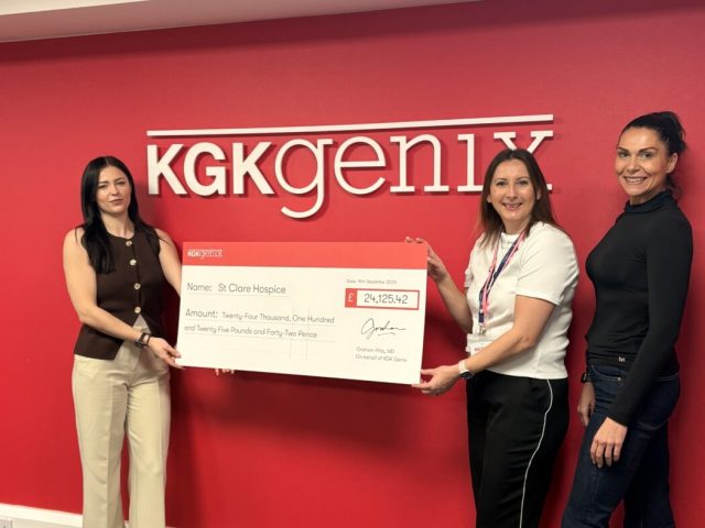 Three women holding a cheque from KGK Genix to St Clare Hospice