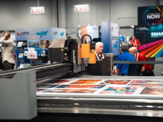 A Kongsberg digital cutting table in operation at a trade fair