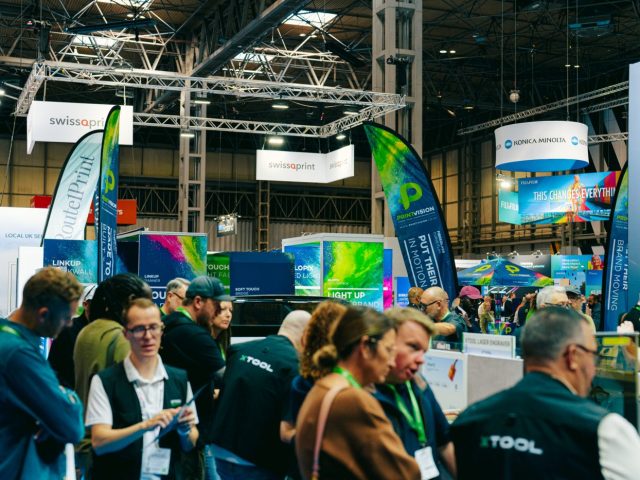 Busy exhibition aisles with visitors and machinery demonstrations inside Hall 1 at The Print Show 2026.