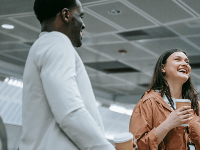 Two people sharing a joke at work to represent how The Printing Charity provide support all year round, not just on Blue Monday
