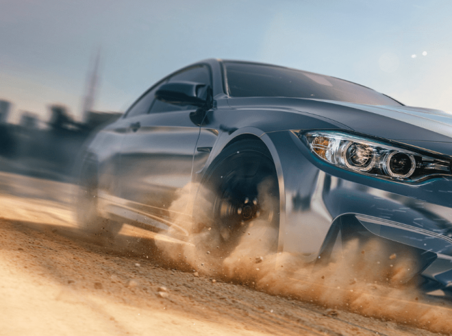 High end car wrapped in paint protection film from William Smith driving over dusty road