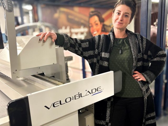 Roisin Hennessy, co-owner of Xtreme Signs & Graphics, stands alongside the company's new Veloblade Nexus 3032