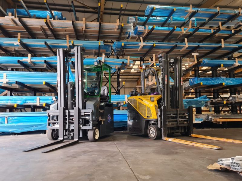 The new Combi-CBE Multi-Directional Electric Forklift (L), alongside its predecessor in the STS warehouse
