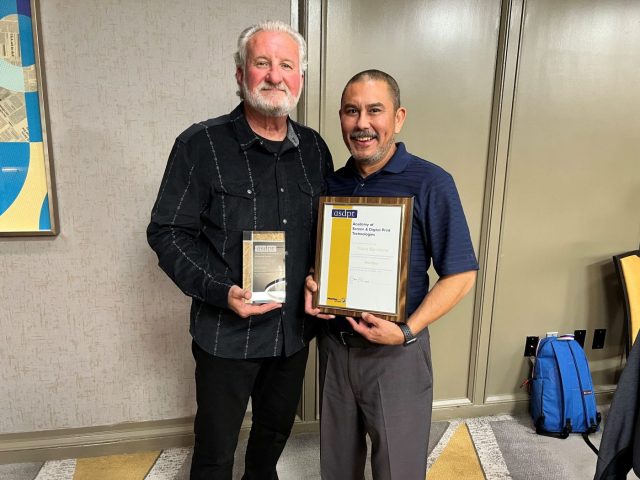 Image shows Bruce Ridge (L) and Travis Barcelona (R) with their awards.