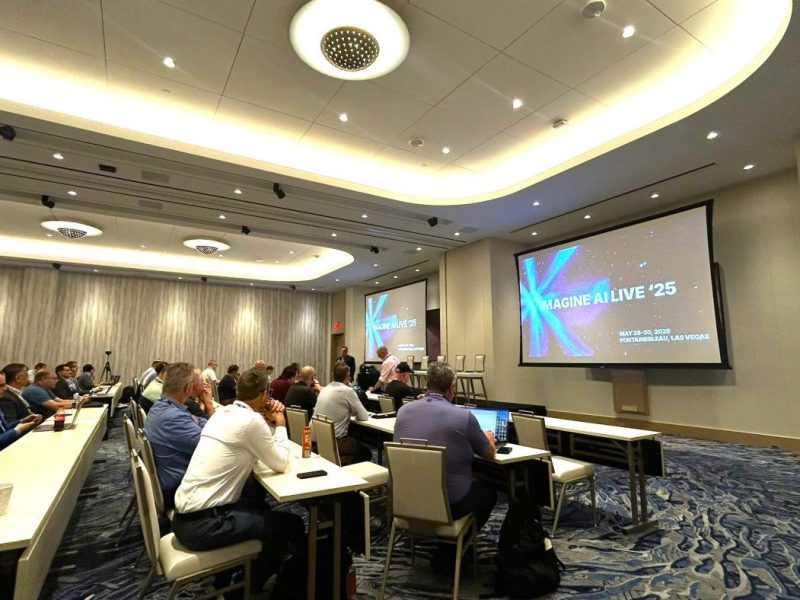 Image shows conference delegates listening to Steve Metcalf at IMAGINE AI Live event