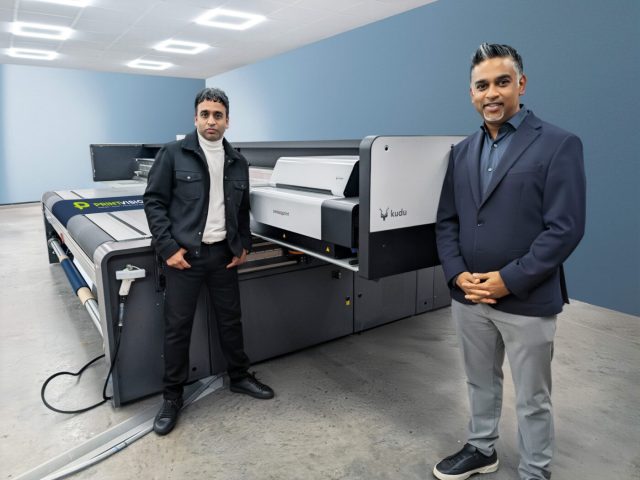 Ash and Krit Patel of PrintVision stood next to their swissQprint Kudu large format printer
