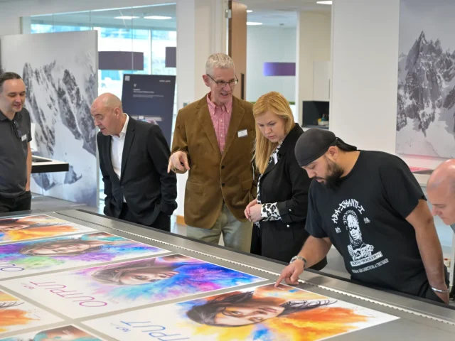 group examining images produced on swissQprint generation 5 flatbed printers at open day